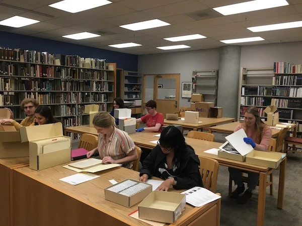 Students researching at tables