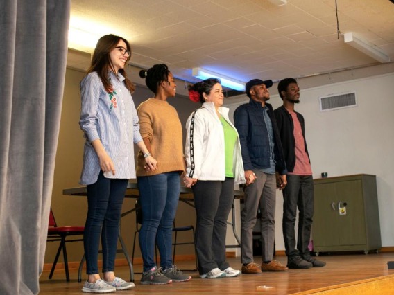 students standing for a curtain call